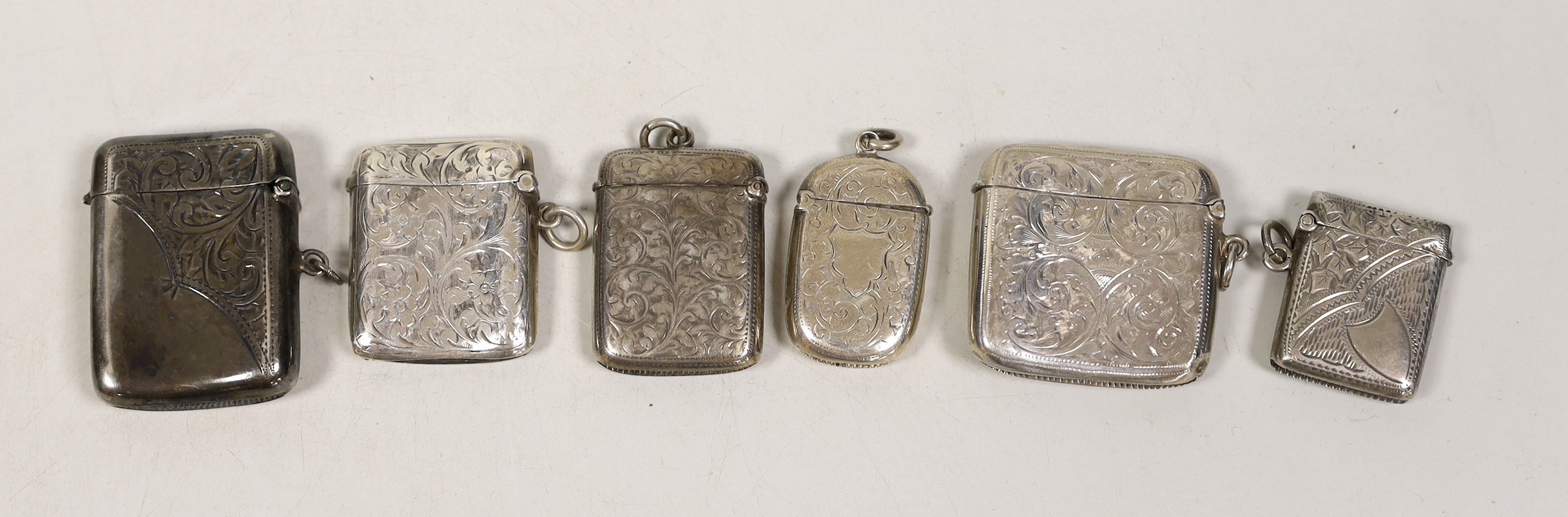 Six assorted mainly early 20th century engraved silver vesta cases, largest 56mm.